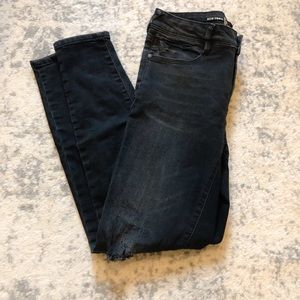 Black distressed skinny jeans with zippers bottoms